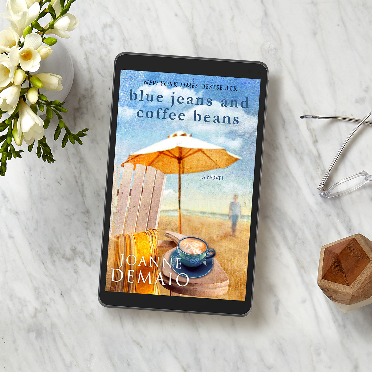 Flatlay of a table with a NOOK tablet device showing the cover of "Blue Jeans and Coffee Beans" 